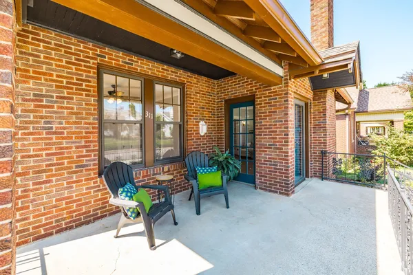 a balcony with with furniture and a potted plant