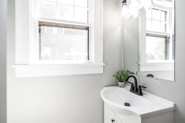 a bathroom with a sink toilet and a mirror