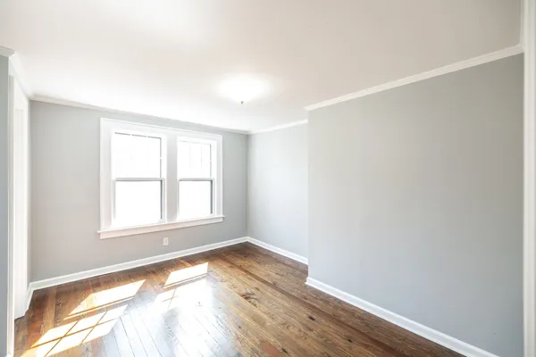 a view of a livingroom with wooden floor and furniture