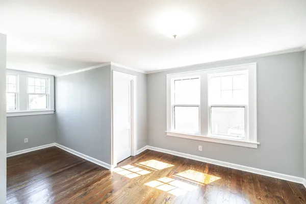 a dining room with wooden floor and a table