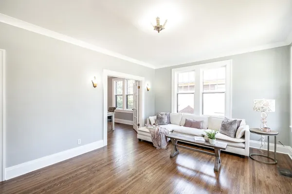 a living room with furniture and wooden floor