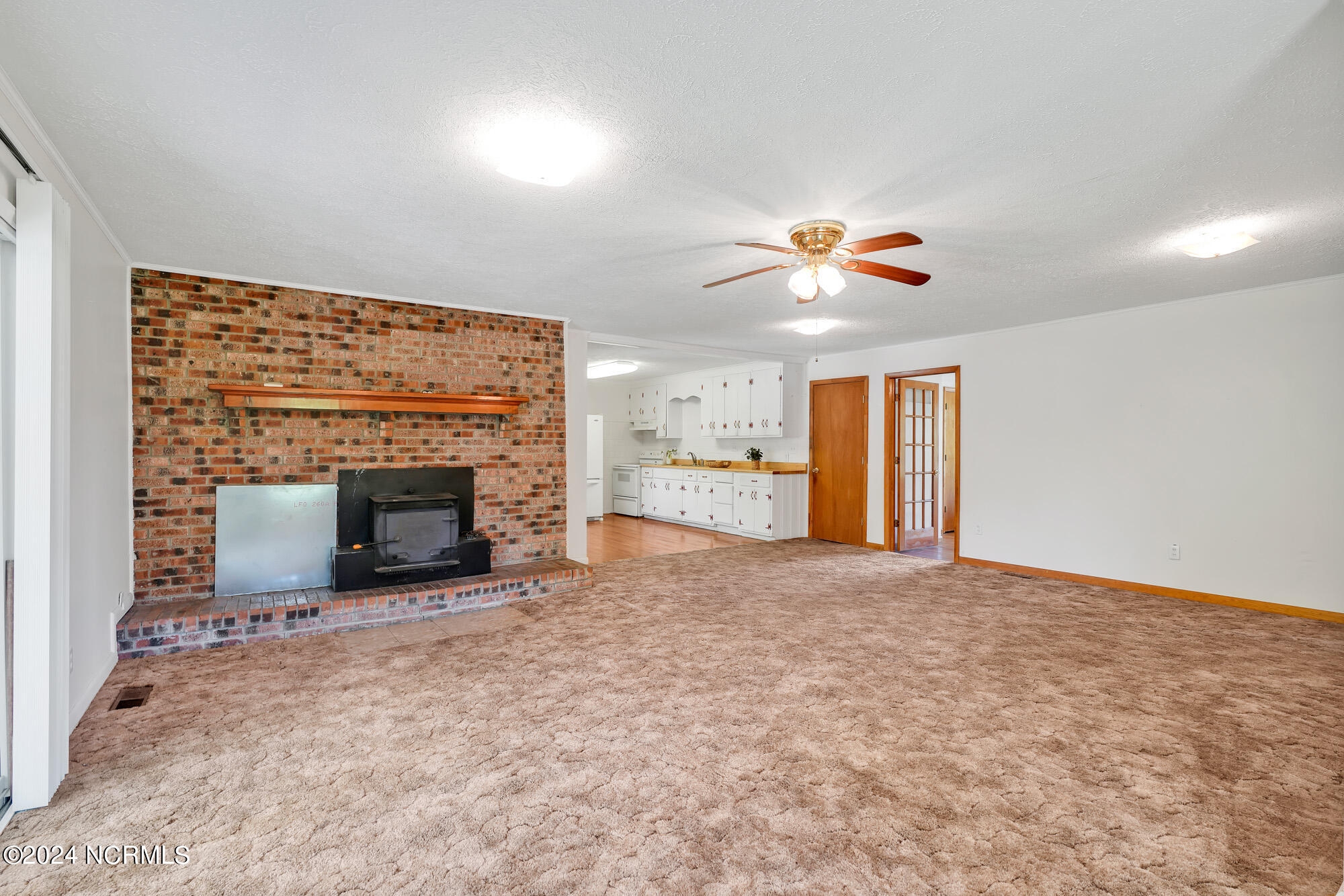83 Maco Road Northeast Leland, NC 28451 - Photo 8 of 39 Fireplace with wood stove in family room.