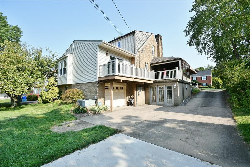 1260 Prospect Road Pittsburgh, PA 15227 - Photo 24 of 25 Here you can see the full length of the side deck and patio along with the open feeling entrance into the lower level office.
