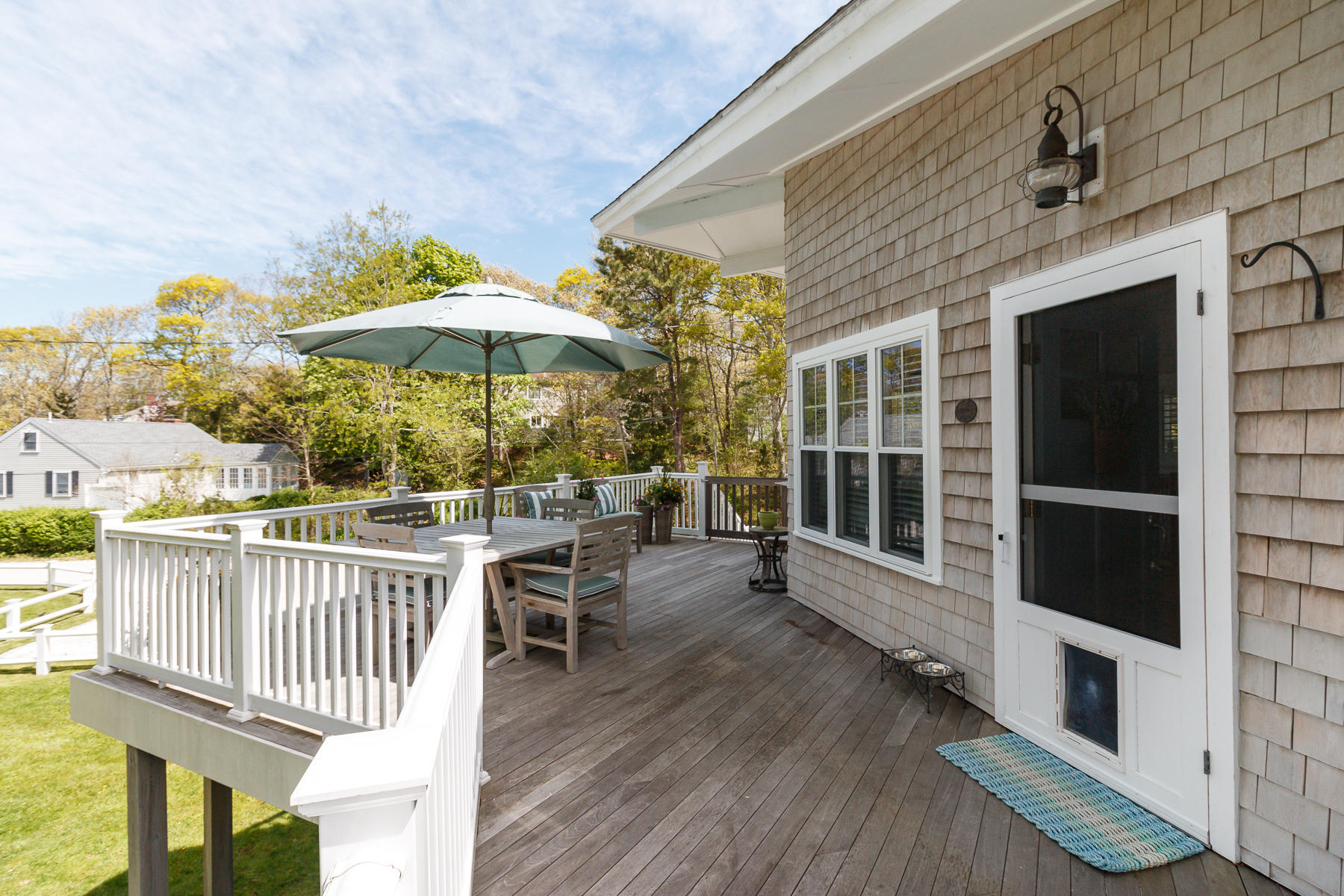 49 Old Shore Road Falmouth, MA 02540 - Photo 7 of 31 a view of a patio with a table and chairs