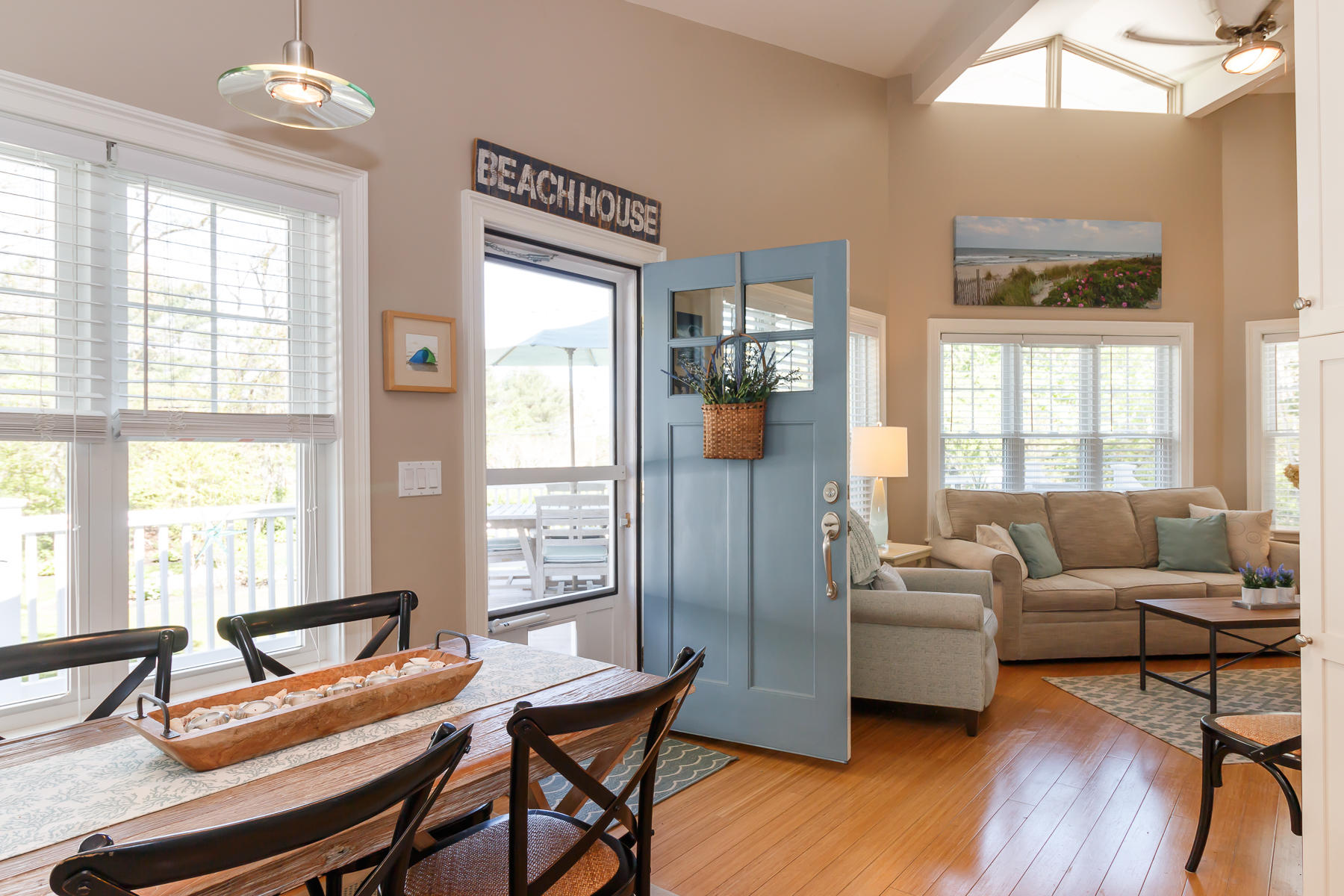 49 Old Shore Road Falmouth, MA 02540 - Photo 8 of 31 a living room with furniture a large window and wooden floor