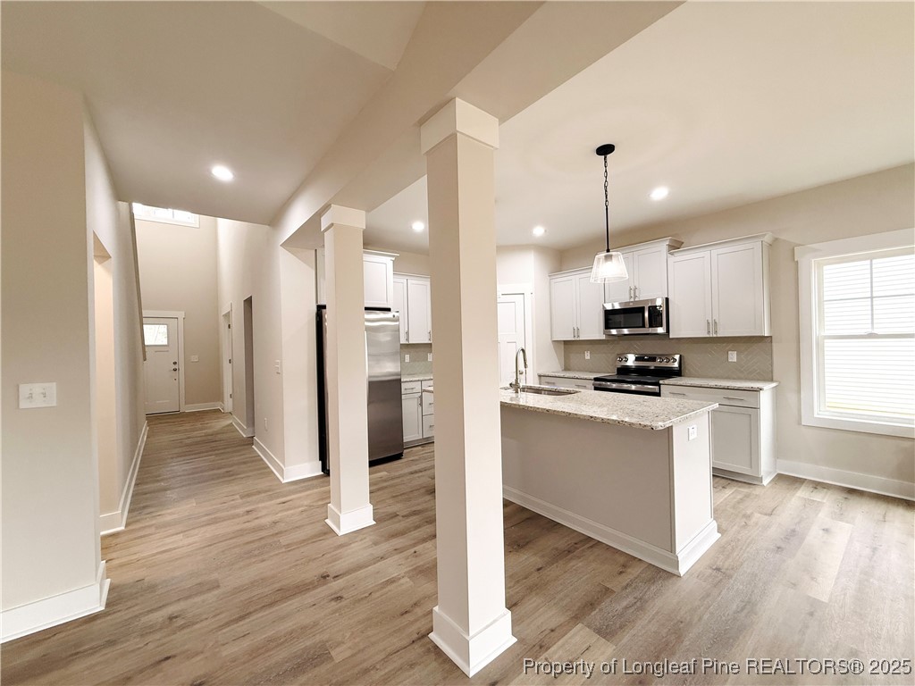 279 Elijah Way Vass, NC 28394 - Photo 12 of 36 a view of kitchen with stainless steel appliances refrigerator stove microwave and cabinets