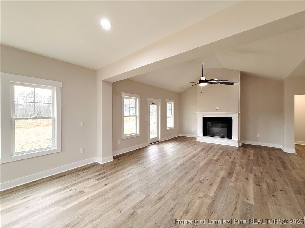 279 Elijah Way Vass, NC 28394 - Photo 15 of 36 an empty room with windows and fireplace