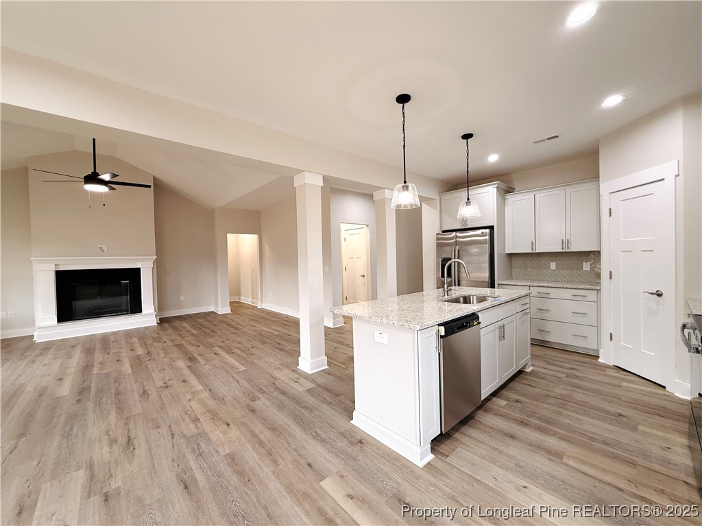 279 Elijah Way Vass, NC 28394 - Photo 17 of 36 a large kitchen with stainless steel appliances granite countertop a stove oven and a refrigerator