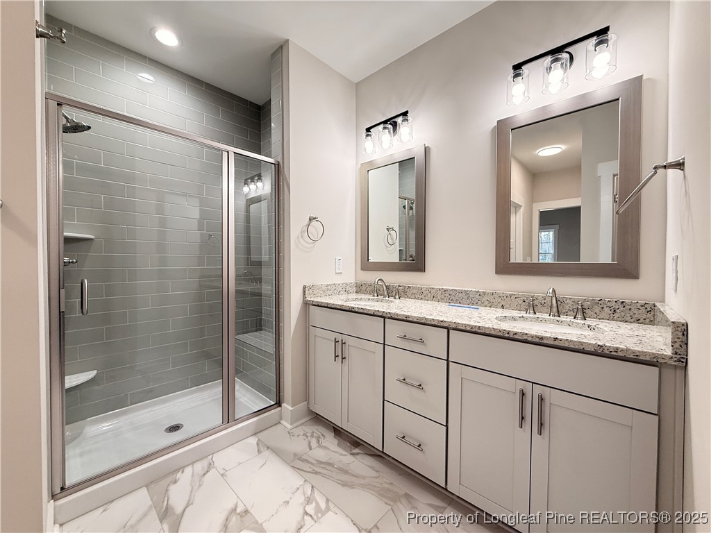279 Elijah Way Vass, NC 28394 - Photo 23 of 36 a bathroom with double vanity and a mirror