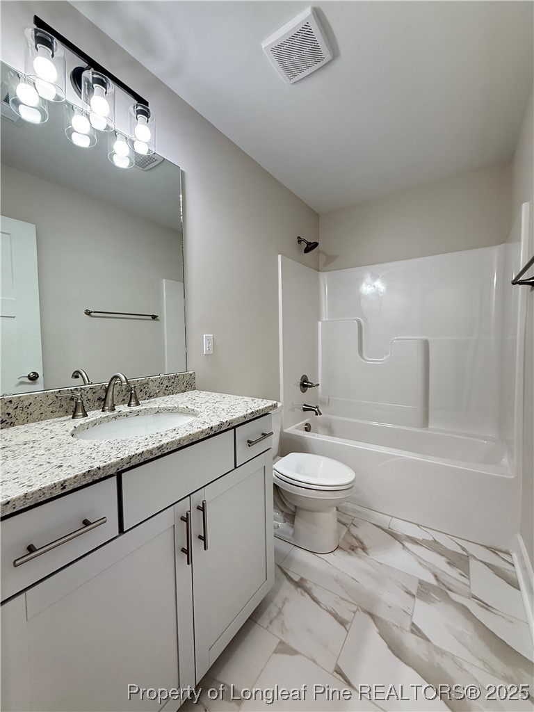 279 Elijah Way Vass, NC 28394 - Photo 30 of 36 a bathroom with a granite countertop toilet sink and a bathtub