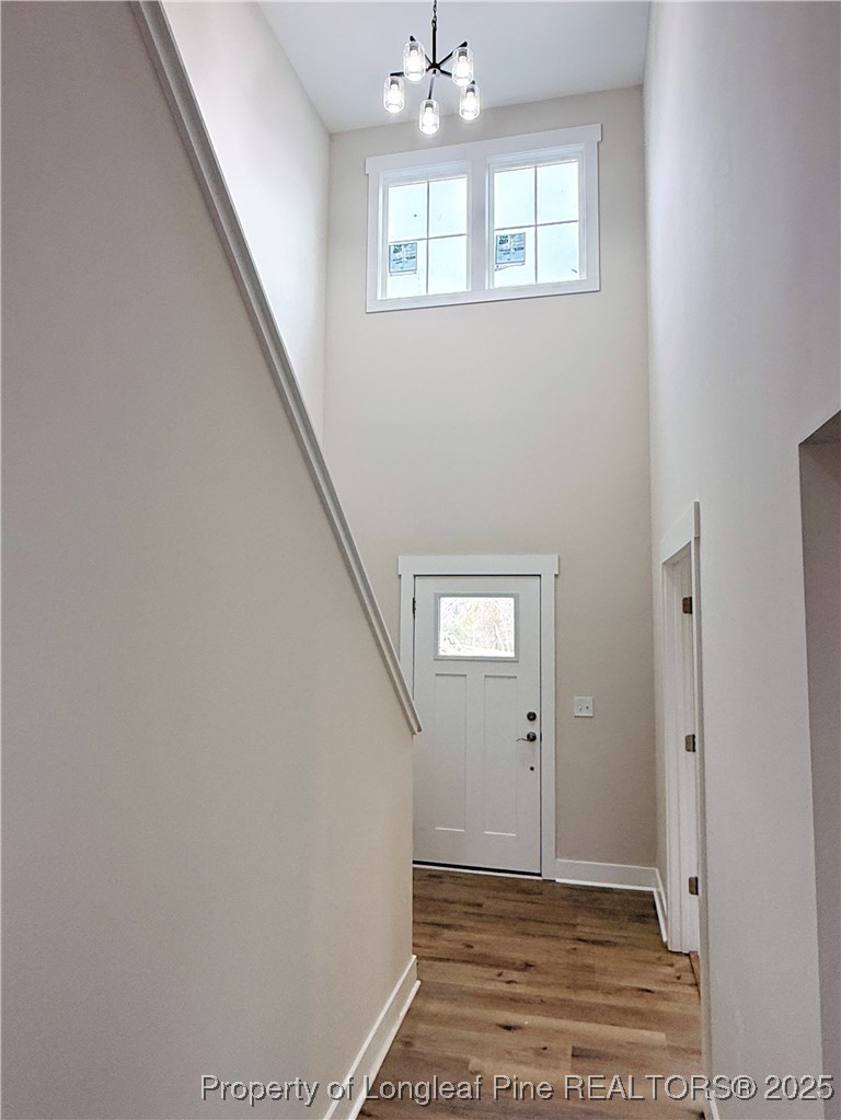 279 Elijah Way Vass, NC 28394 - Photo 4 of 36 a view of an empty room with wooden floor and a window