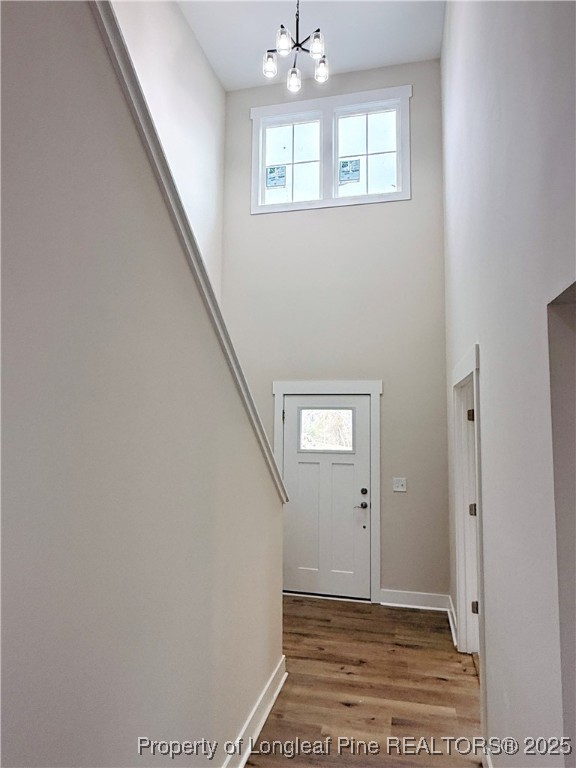 279 Elijah Way Vass, NC 28394 - Photo 4 of 36 a view of an empty room with wooden floor and a window