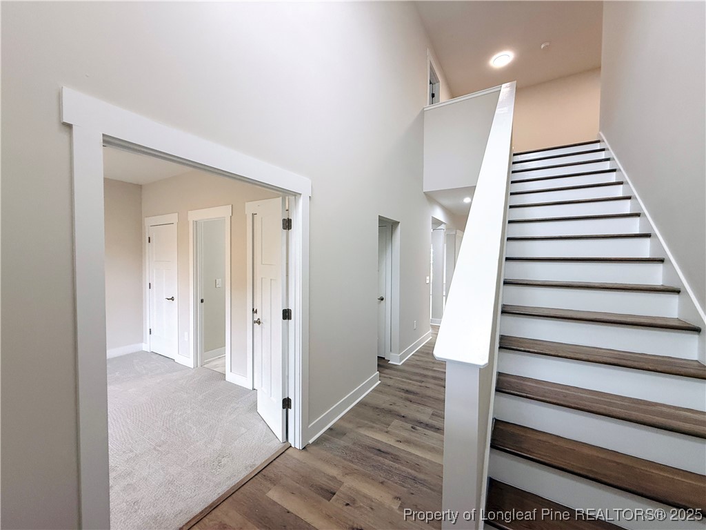 279 Elijah Way Vass, NC 28394 - Photo 5 of 36 a view of a hallway with staircase and white walls