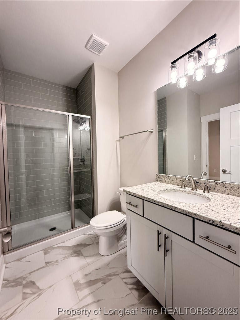 279 Elijah Way Vass, NC 28394 - Photo 8 of 36 a bathroom with a granite countertop sink toilet and shower