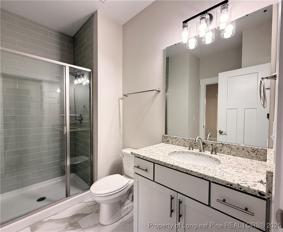 279 Elijah Way Vass, NC 28394 - Photo 9 of 36 a bathroom with a granite countertop sink toilet and shower