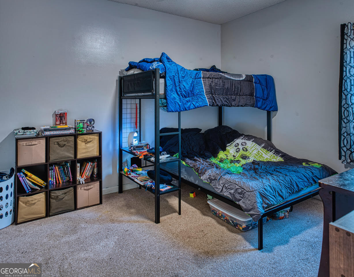 221 Pendleton Court Macon, GA 31216 - Photo 12 of 16 a living room with furniture and a baby crib