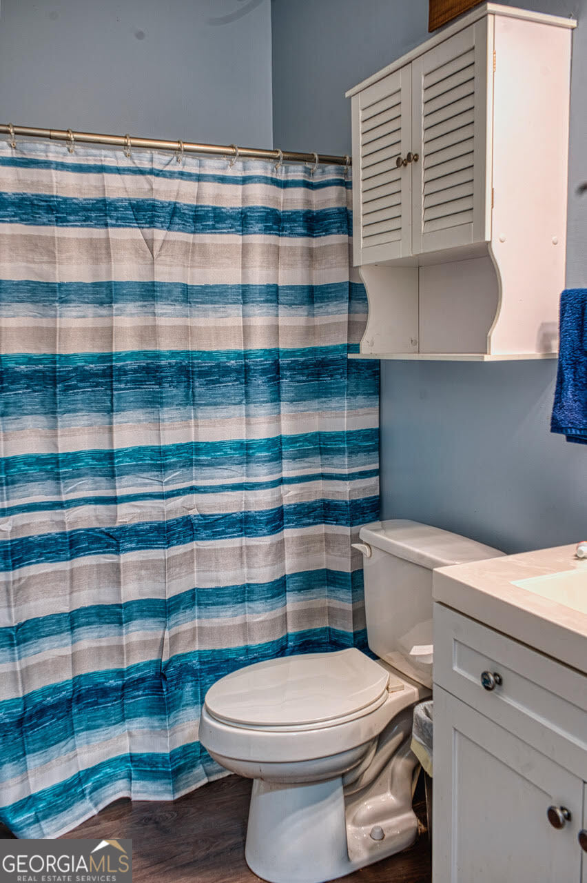 221 Pendleton Court Macon, GA 31216 - Photo 14 of 16 a bathroom with a sink a toilet and a mirror
