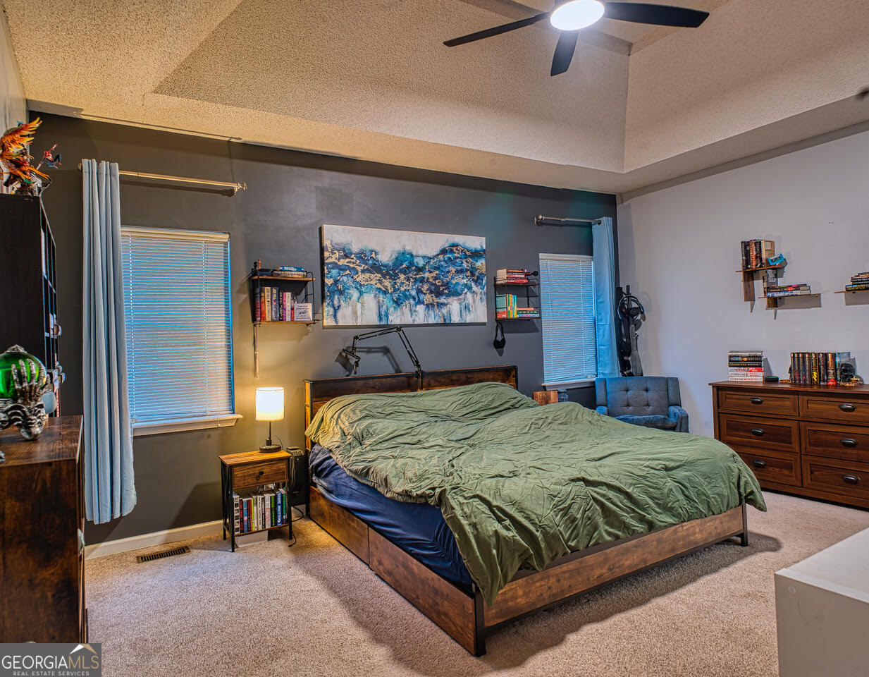 221 Pendleton Court Macon, GA 31216 - Photo 8 of 16 a bedroom with a bed and a chandelier