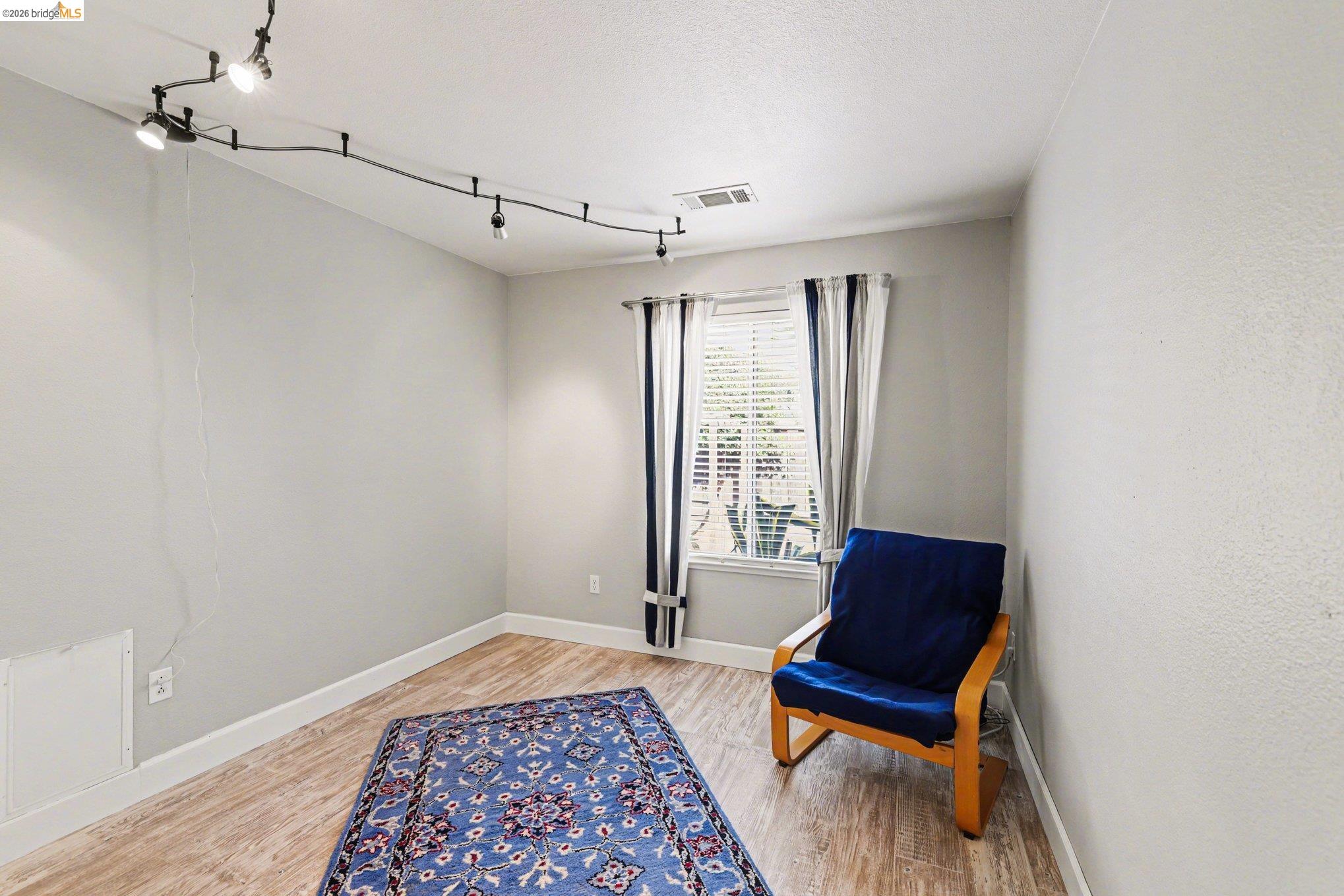 2701 Coffee Tree Way Antioch, CA 94509 - Photo 15 of 29 an empty room with windows and wooden floor