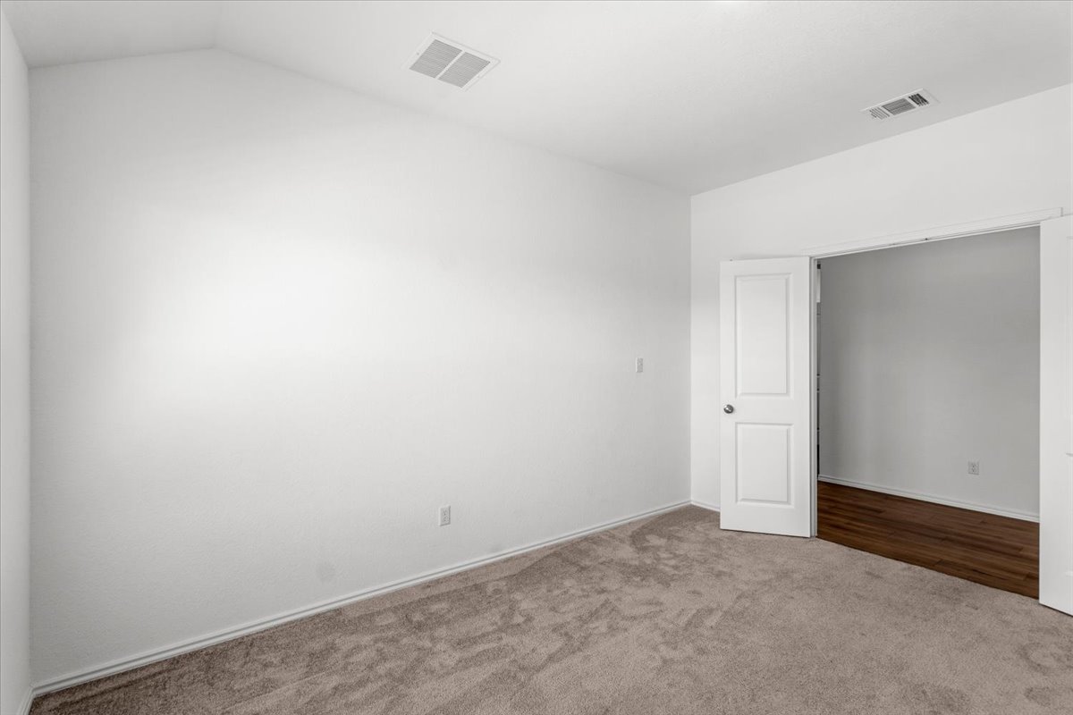 167 Jeffers Kyle, TX 78640 - Photo 20 of 40 Carpeted empty room featuring lofted ceiling and baseboards