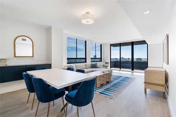 a large kitchen with a table and chairs