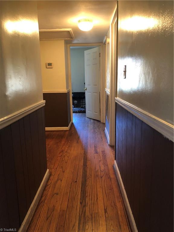 3630 Harvard Road Winston-Salem, NC 27107 - Photo 6 of 16 Hall way to bathroom, laundry, half bath, and bedrooms 1,2, and 3. Original hardwoods in every room but Baths, Kitchen, dining and laundry.