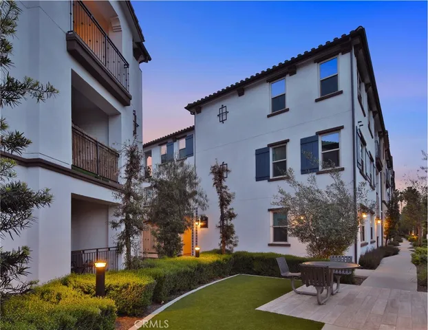 a view of a patio with couches table and chairs and potted plants