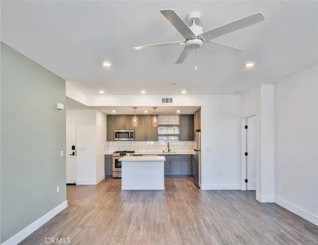 a kitchen with stainless steel appliances a sink stove and cabinets