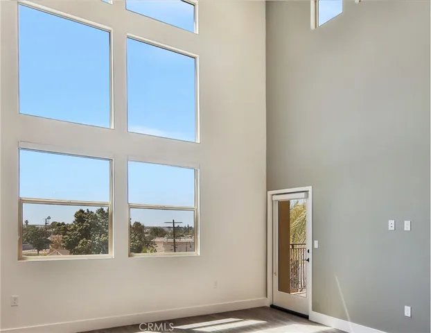 a view of staircase and kitchen with wooden floor