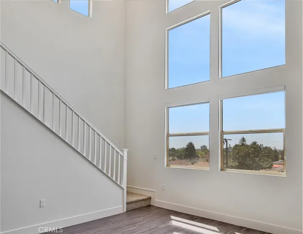 a view of kitchen with kitchen island white cabinets and stainless steel appliances