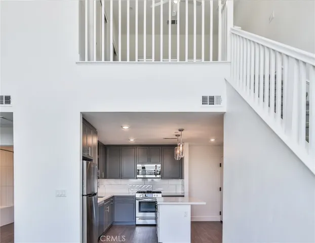 wooden floor in an empty room with a ceiling fan