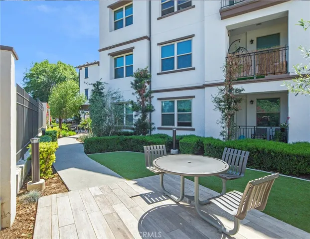 a view of a patio with table and chairs couches with wooden floor and fence