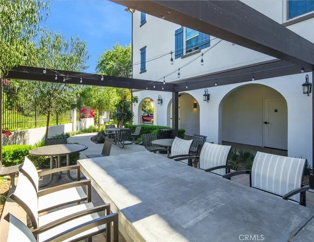 a living room with furniture a large window and a chandelier