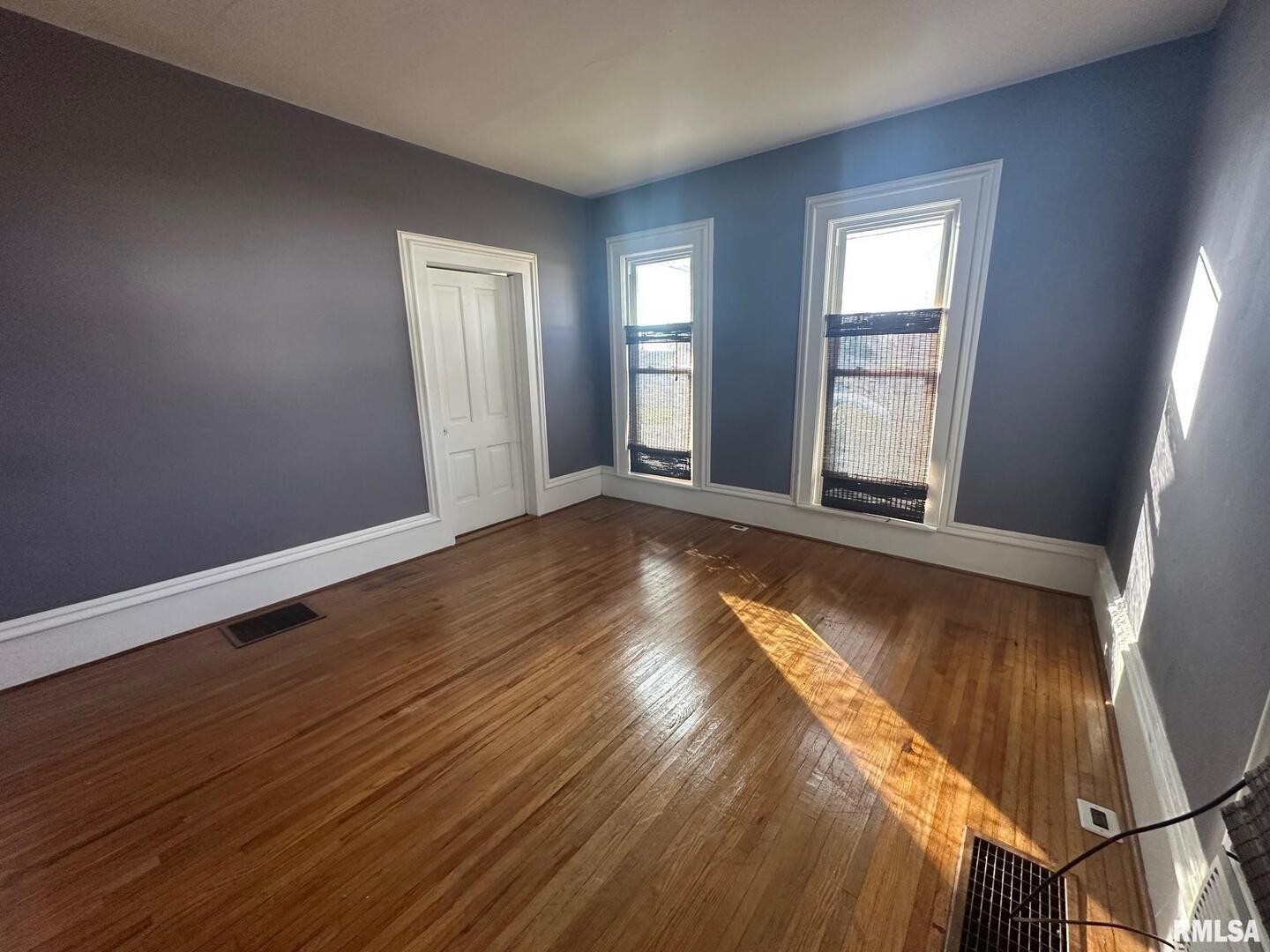 323 Lincoln Street Miles, IA 52064 - Photo 6 of 34 a view of an empty room with wooden floor and a window