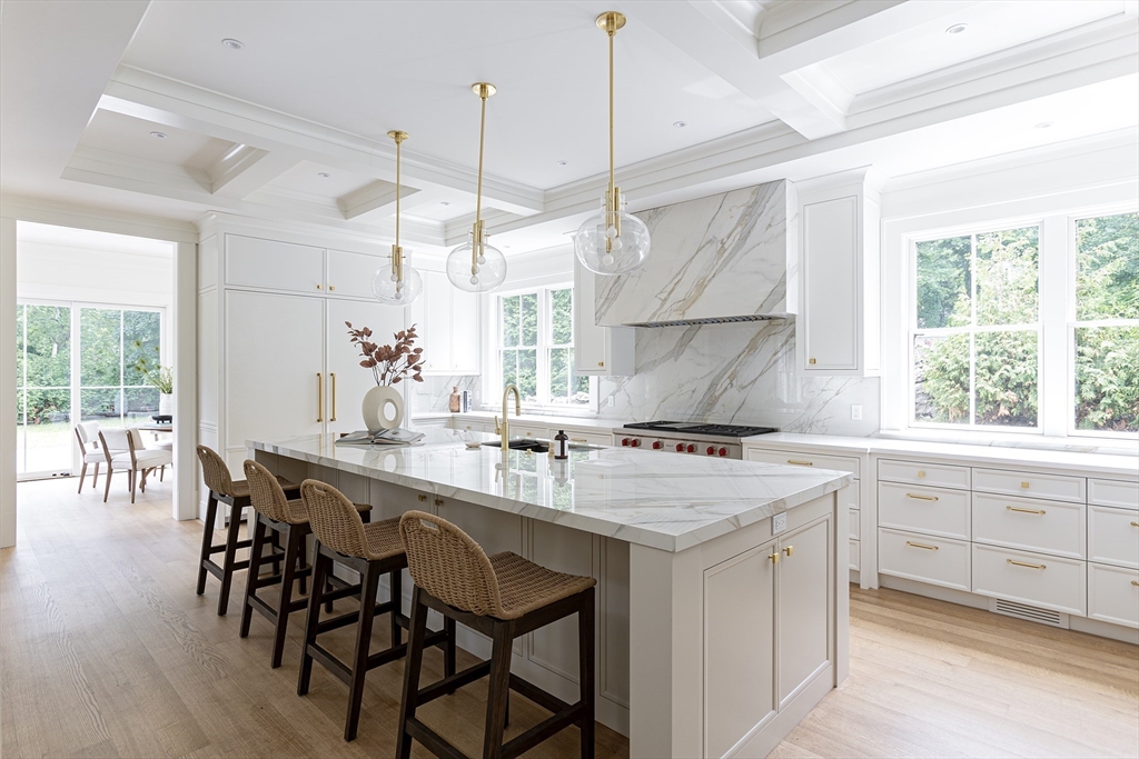 68 Clyde Street Brookline, MA 02445 - Photo 13 of 25 a kitchen with a stove a sink a dining table and chairs