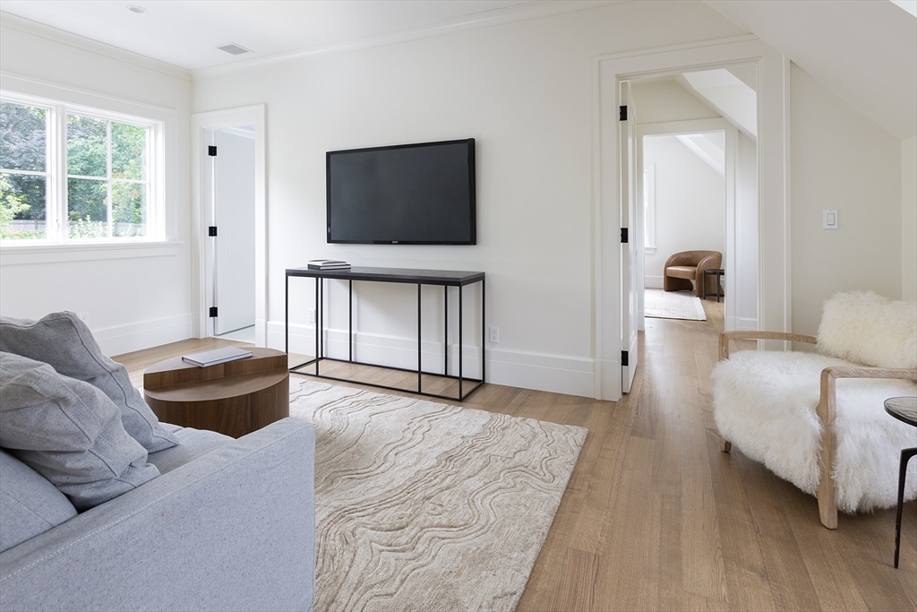 68 Clyde Street Brookline, MA 02445 - Photo 22 of 25 a living room with furniture and a flat screen tv