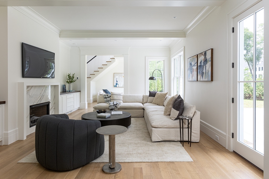 68 Clyde Street Brookline, MA 02445 - Photo 7 of 25 a living room with furniture a fireplace and a flat screen tv