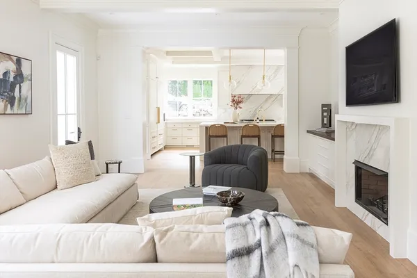a living room with furniture a flat screen tv and a fireplace