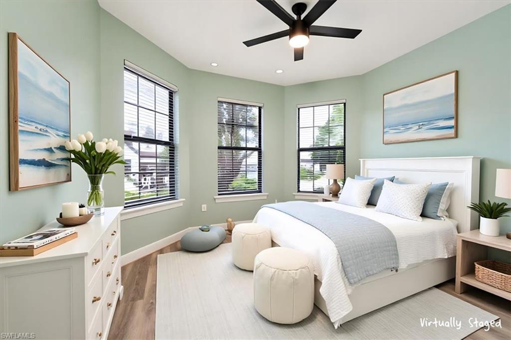 Bedroom featuring wood finished floors, ceiling fan, and recessed lighting