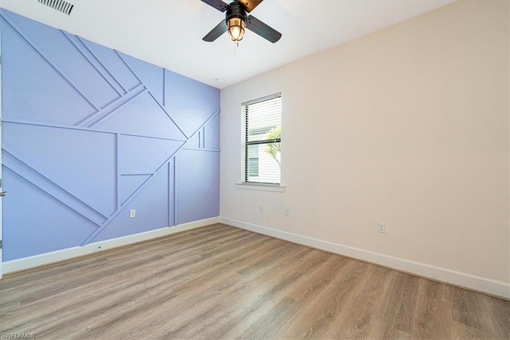 1996 Parson Street Naples, FL 34120 - Photo 15 of 50 Empty room featuring wood finished floors and ceiling fan
