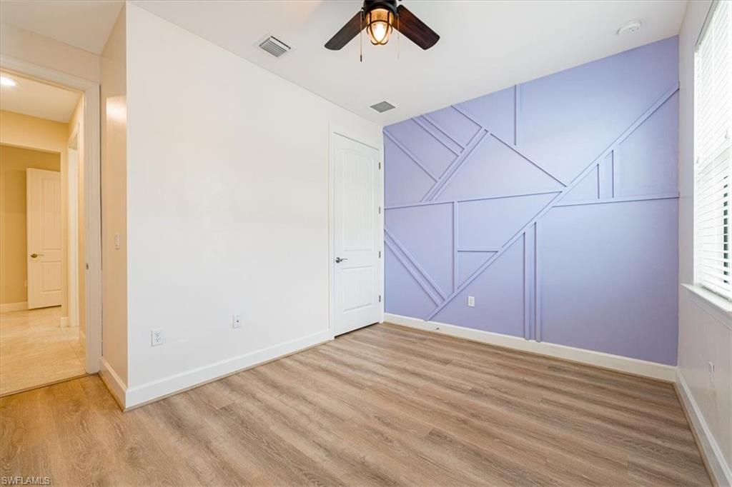 1996 Parson Street Naples, FL 34120 - Photo 16 of 50 Empty room featuring ceiling fan and wood finished floors