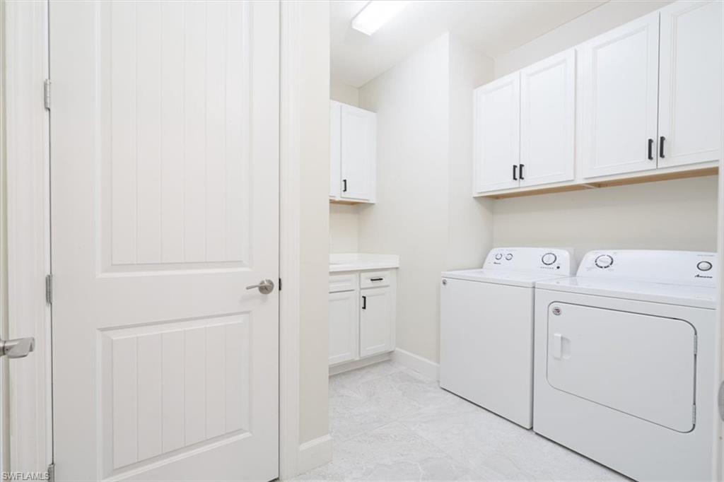 1996 Parson Street Naples, FL 34120 - Photo 17 of 50 Laundry room featuring cabinet space and washer and dryer