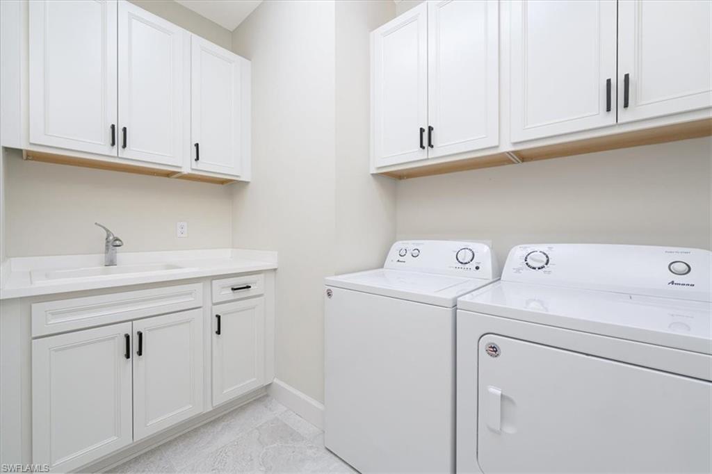 1996 Parson Street Naples, FL 34120 - Photo 18 of 50 Laundry area with cabinet space and separate washer and dryer