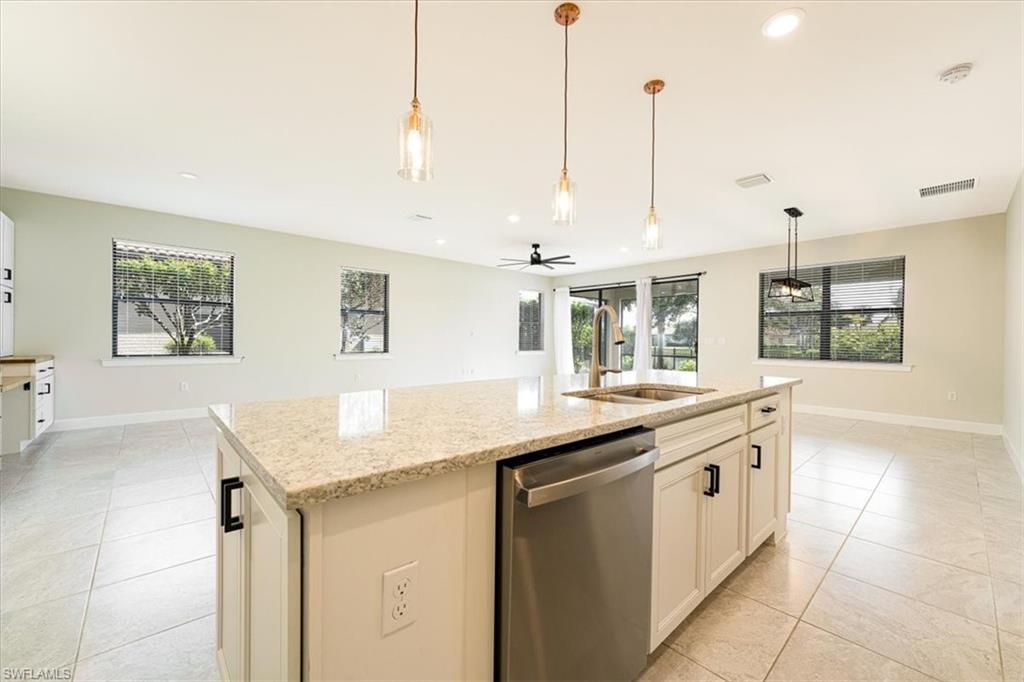 1996 Parson Street Naples, FL 34120 - Photo 21 of 50 Kitchen with dishwasher, plenty of natural light, light stone counters, ceiling fan, and recessed lighting