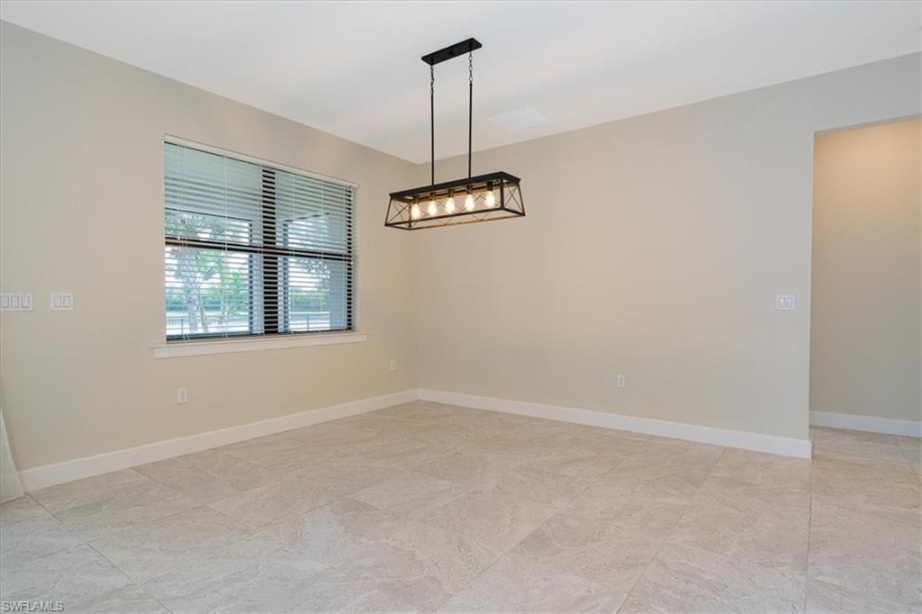 1996 Parson Street Naples, FL 34120 - Photo 23 of 50 Empty room with baseboards and a chandelier