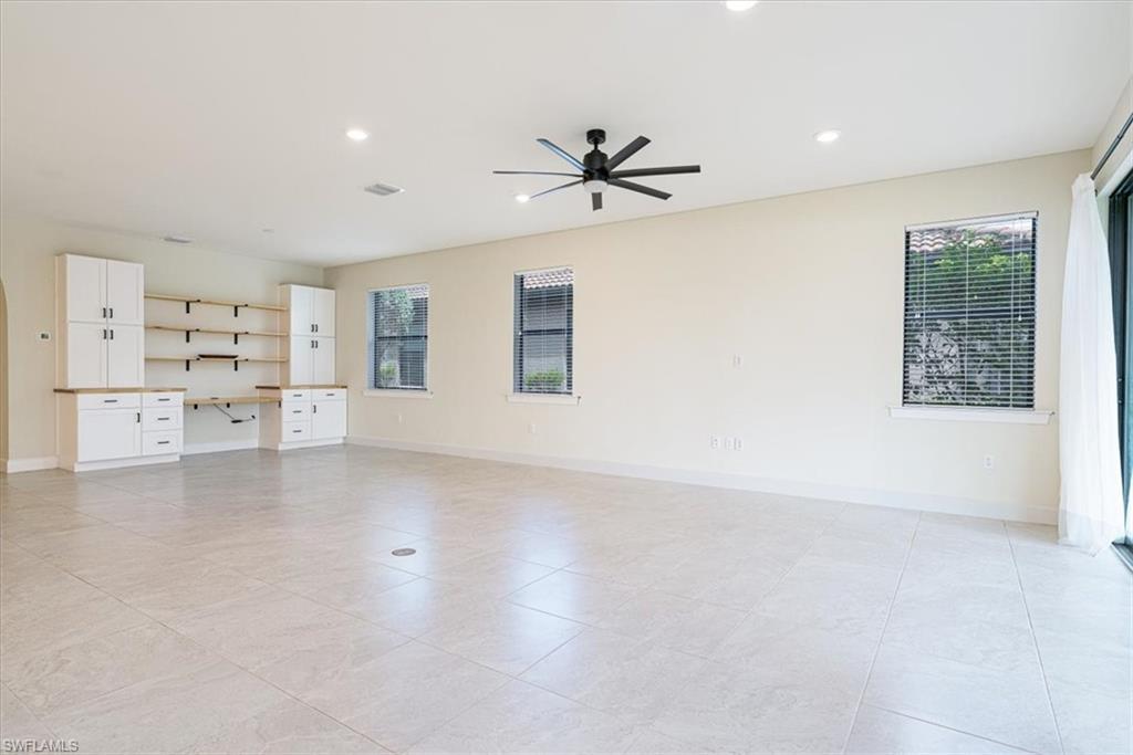 1996 Parson Street Naples, FL 34120 - Photo 25 of 50 Empty room featuring built in study area, healthy amount of natural light, recessed lighting, a ceiling fan, and light tile patterned floors
