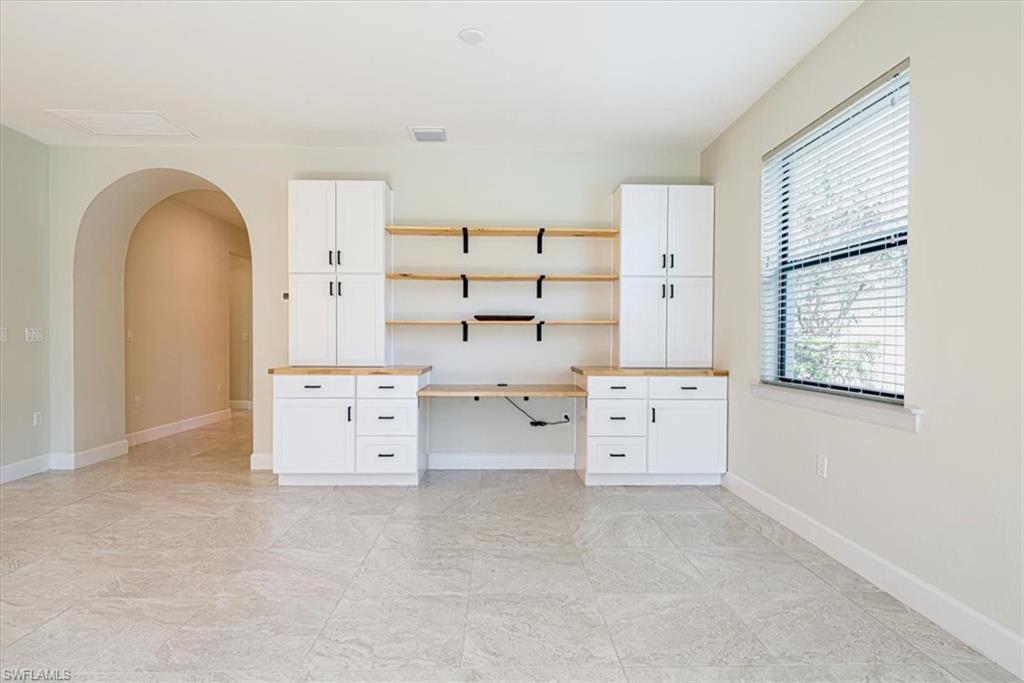 1996 Parson Street Naples, FL 34120 - Photo 26 of 50 Unfurnished office featuring arched walkways and built in desk