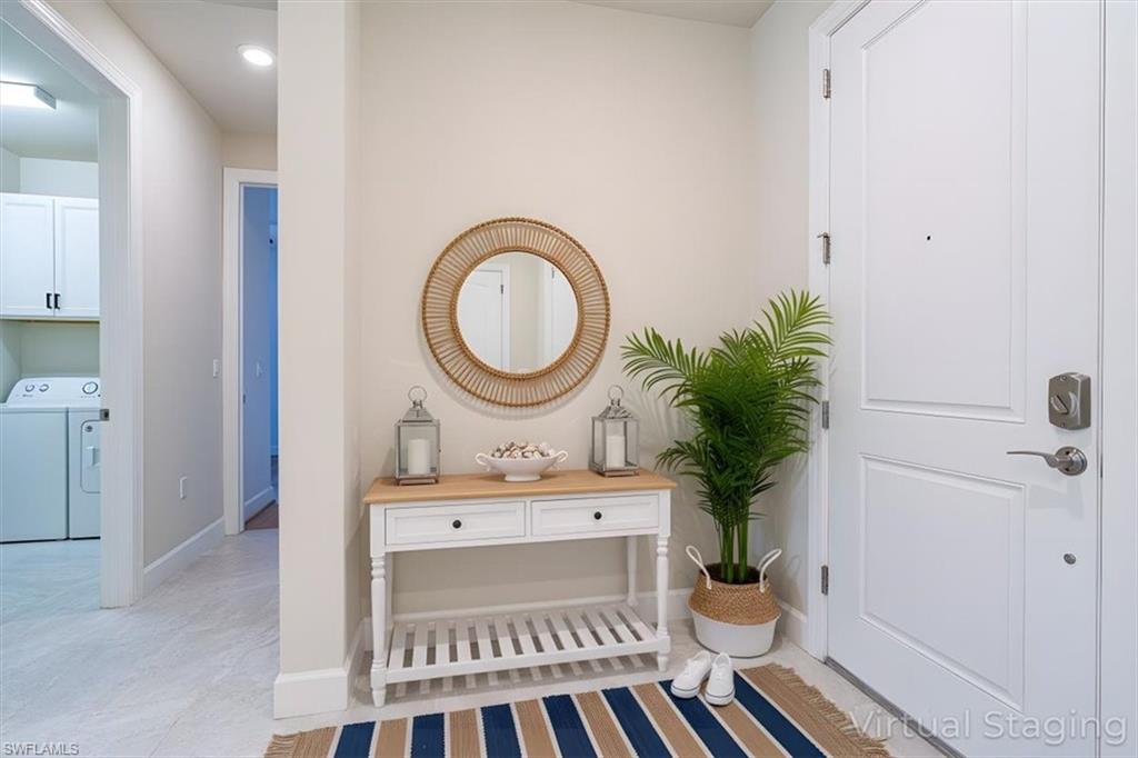 1996 Parson Street Naples, FL 34120 - Photo 5 of 50 Entrance foyer featuring washing machine and dryer and light tile patterned floors