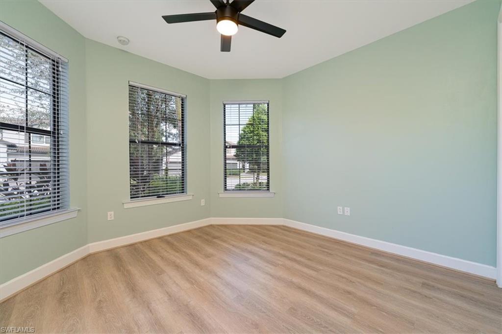 1996 Parson Street Naples, FL 34120 - Photo 9 of 50 Empty room with light wood finished floors and a ceiling fan
