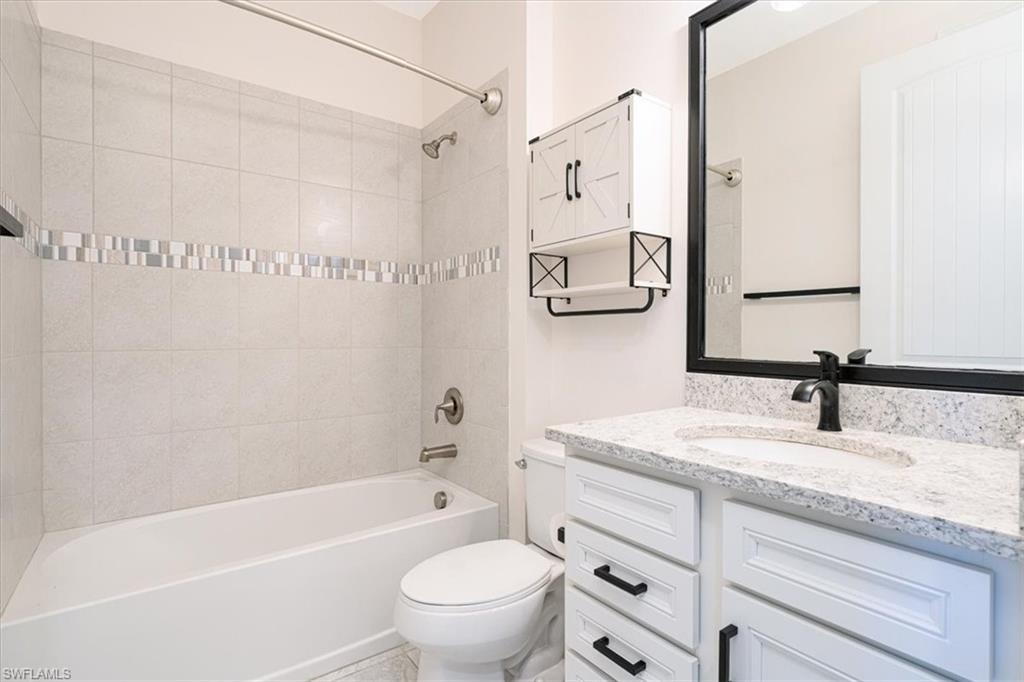 1996 Parson Street Naples, FL 34120 - Photo 10 of 50 Full bathroom featuring vanity and tub / shower combination